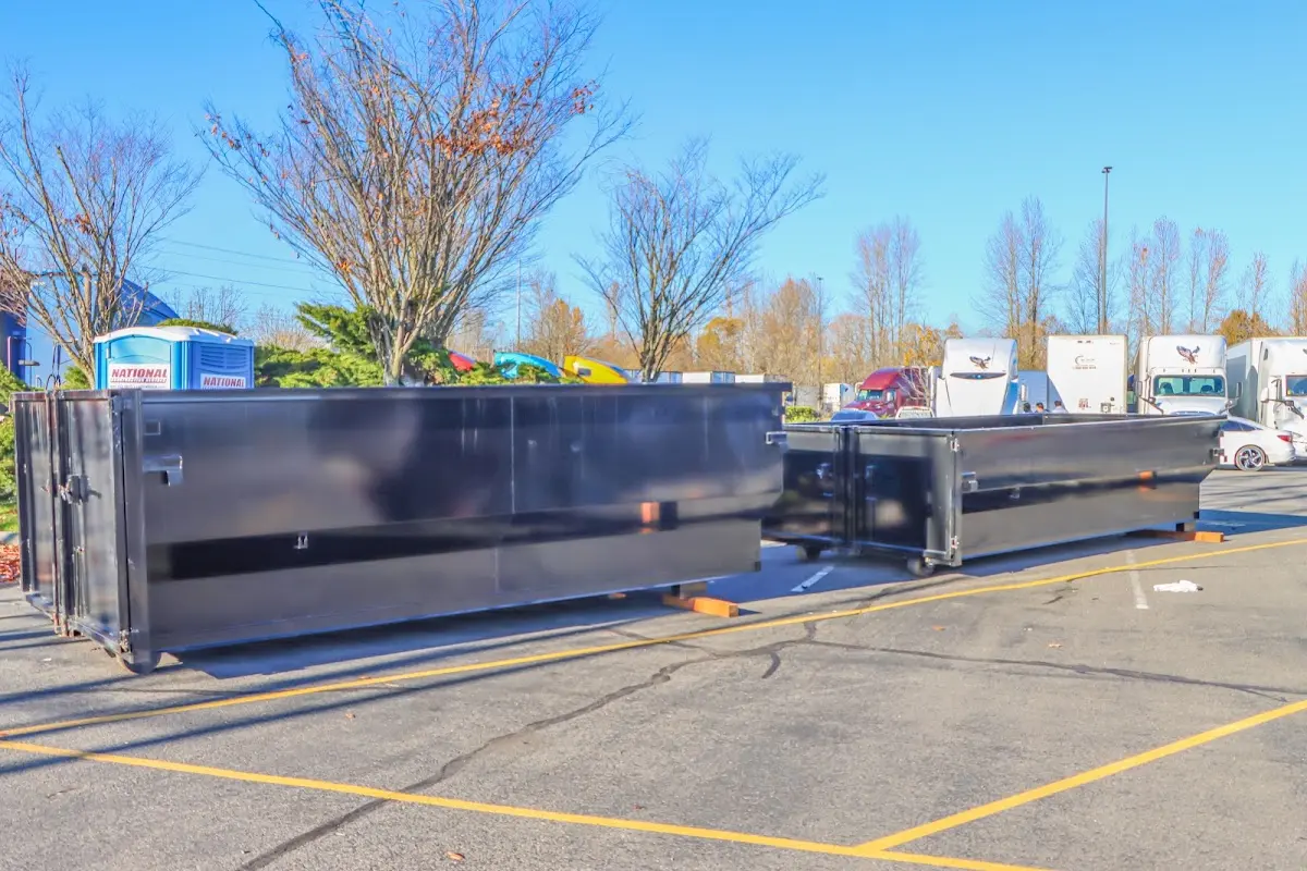 Professional dumpster rental service with roll-off container on residential driveway in Terrell
